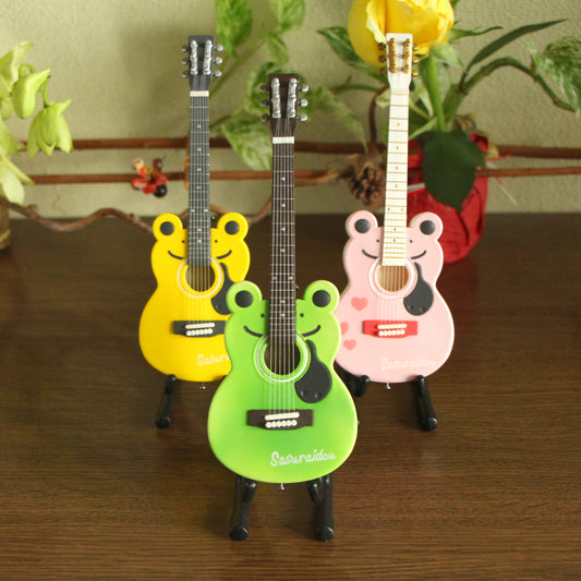 A cute frog-shaped acoustic guitar in a classical style